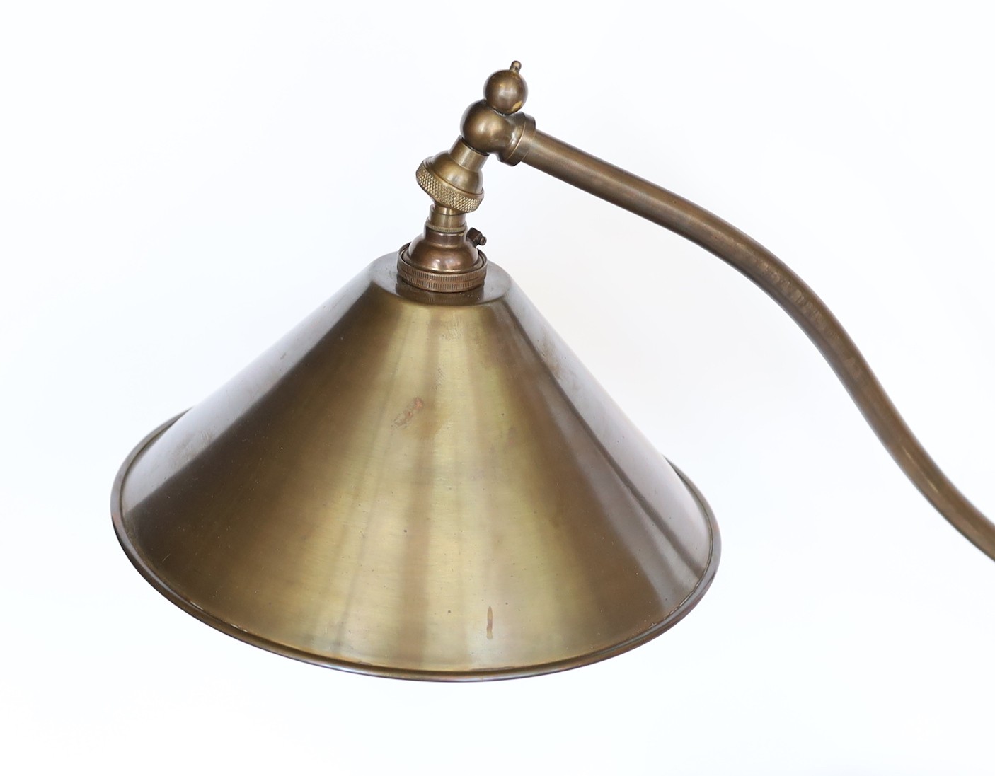 A stylish bronze metal desk lamp with adjustable shade and spherical base, height 53cm